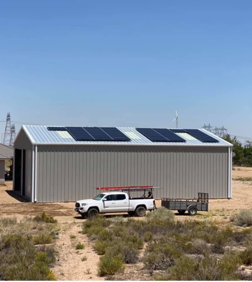 Roof-mounted solar array on a steel shop building in the California High Desert, installed by Van Mierlo Builders and Solar
